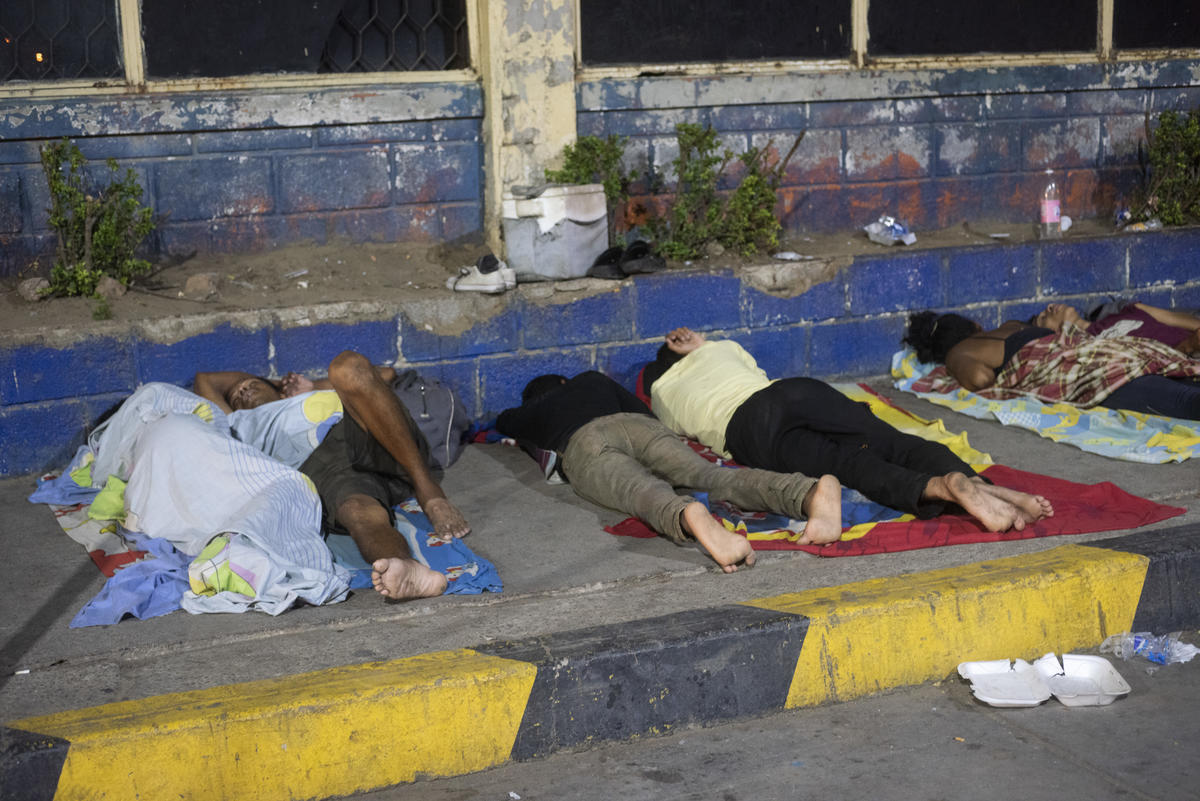 Colombia. Venezuelan migrants sleep in front of the bus terminal in Maicao