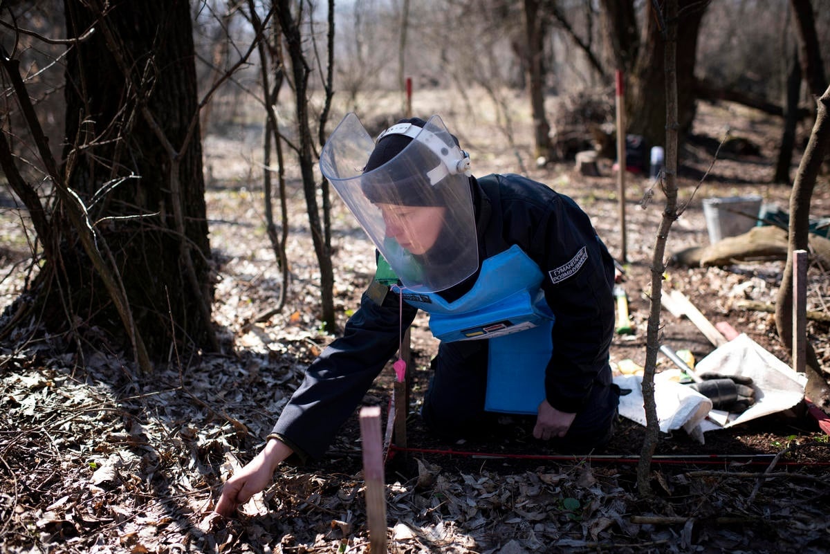 Ukraine. A female deminer looks for landmines in the Donbas area