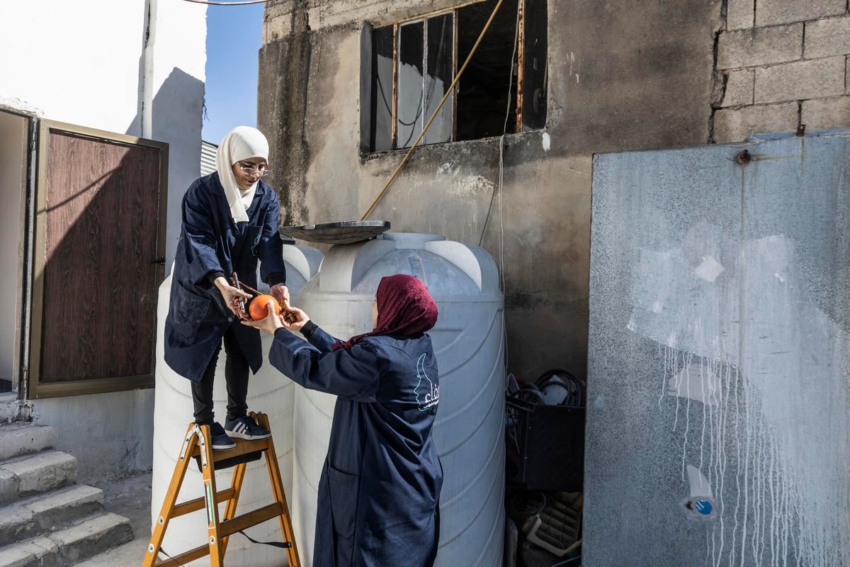 Jordan. Female plumber teaches refugees her trade