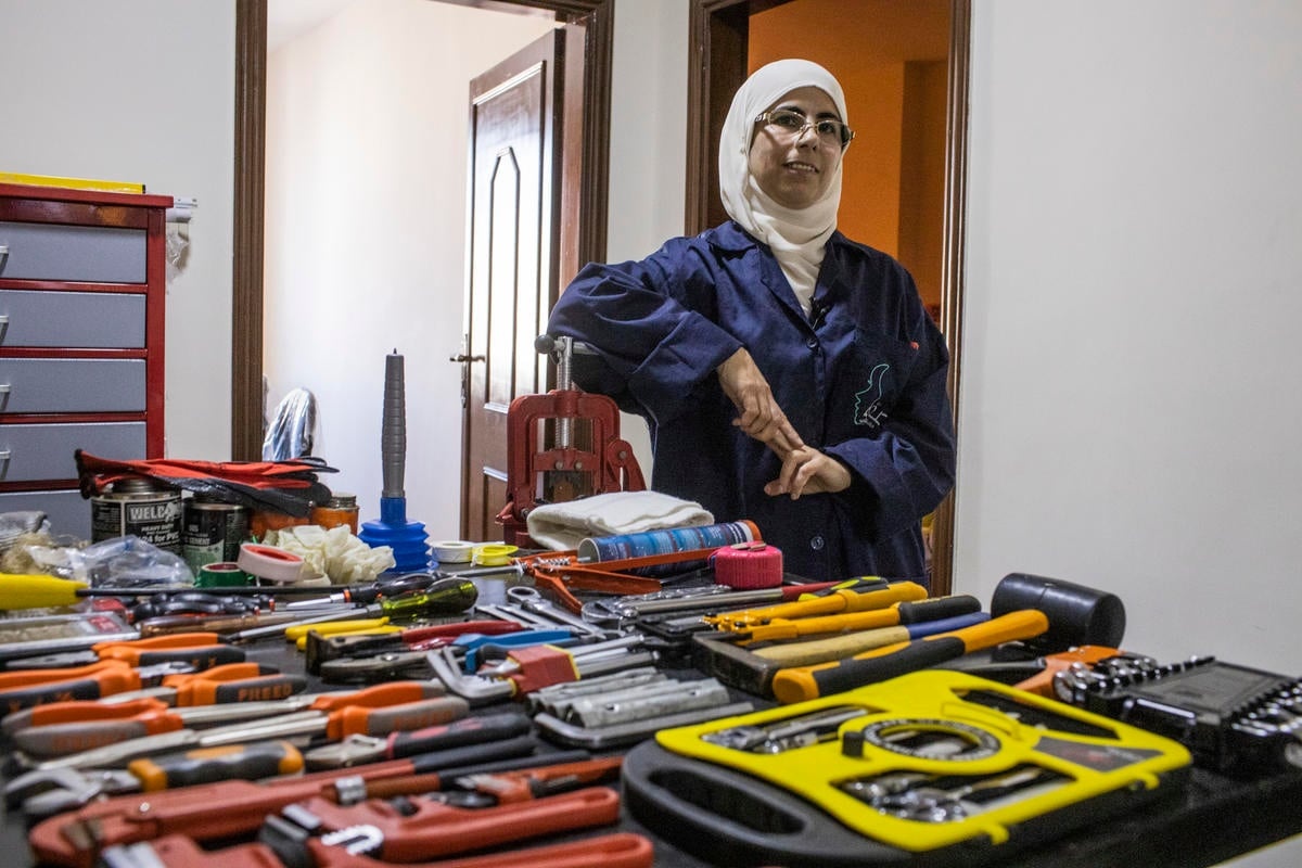 Jordan. Female plumber teaches refugees her trade