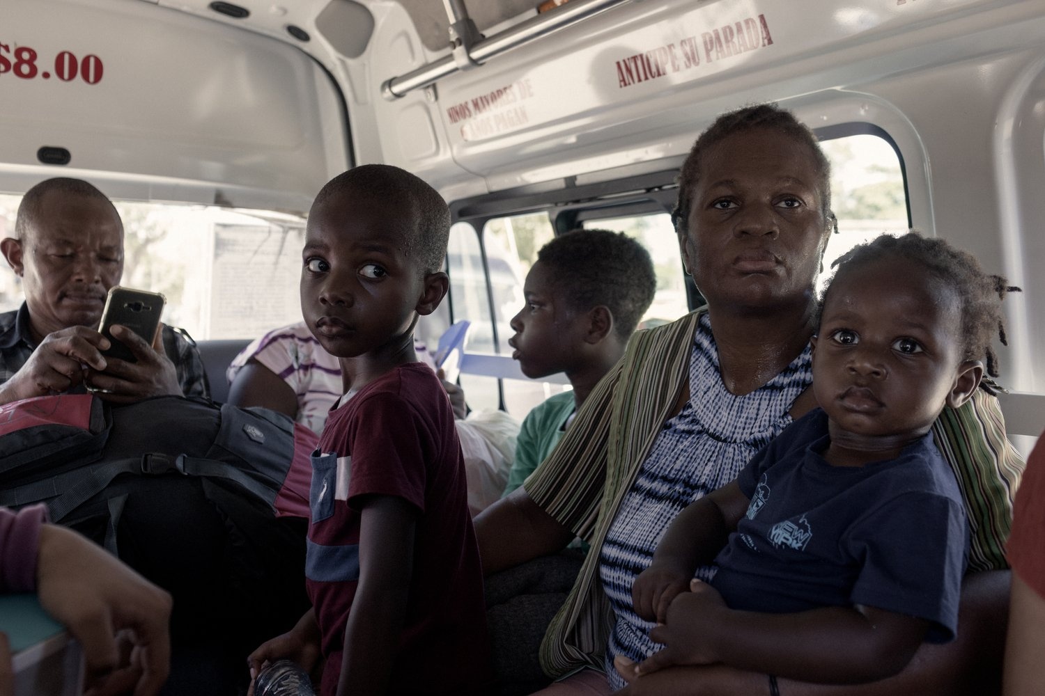 A family sit on a mini-bus.
