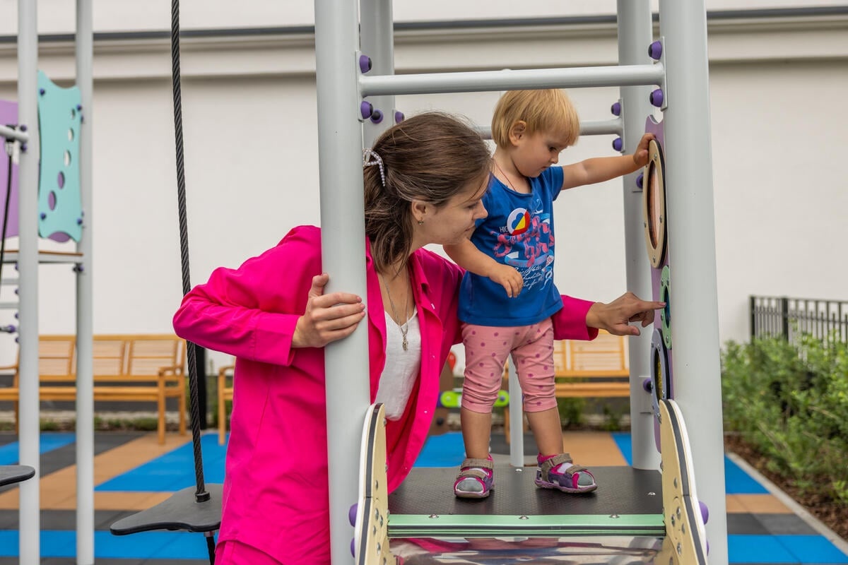 Ella plays with her one-year-old daughter, Zlata. 