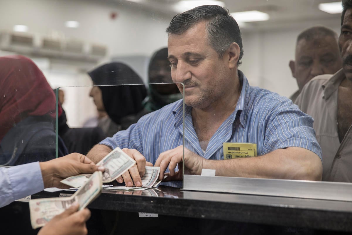 Egypt. Refugees receive UNHCR cash assistance
