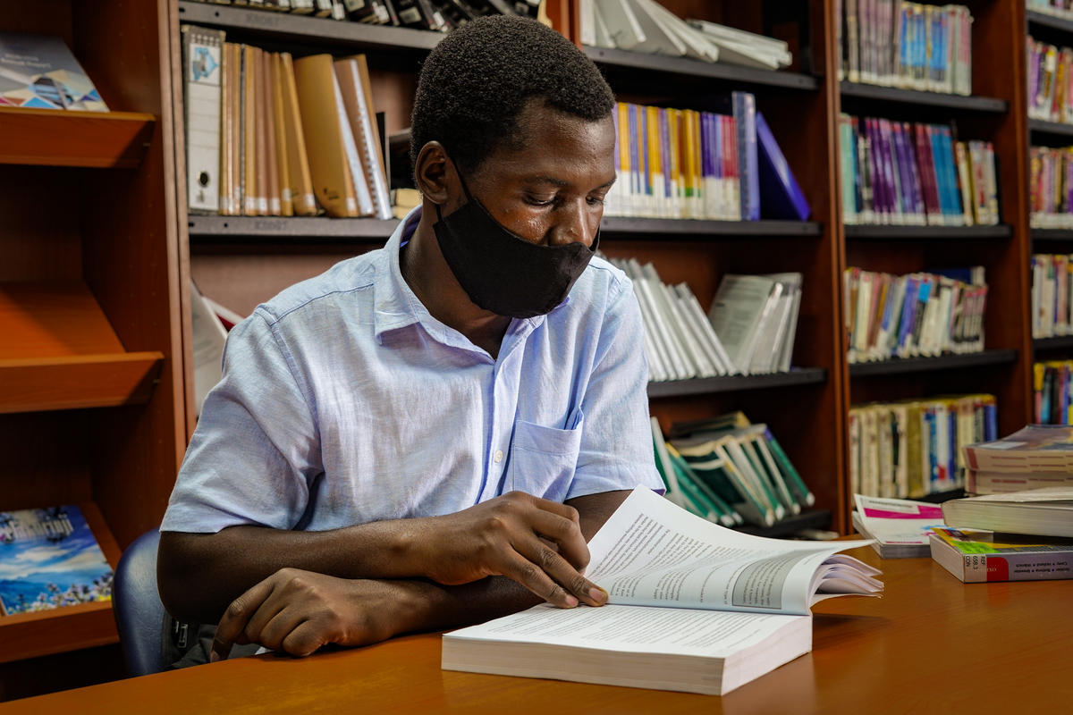 Zimbabwean refugee, Haskins, reads a book at Botho University's library in Gaborone, Botswana where he is doing Business Studies.