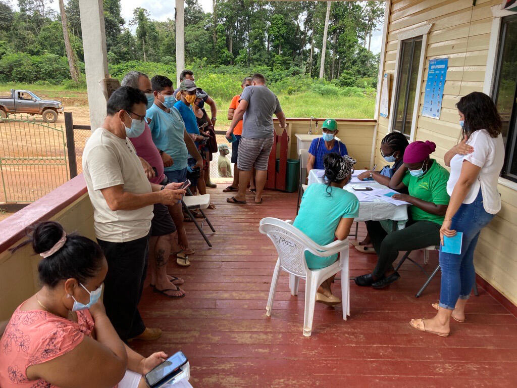 In Guyana, displaced people and locals line up to receive the COVID-19 jab.