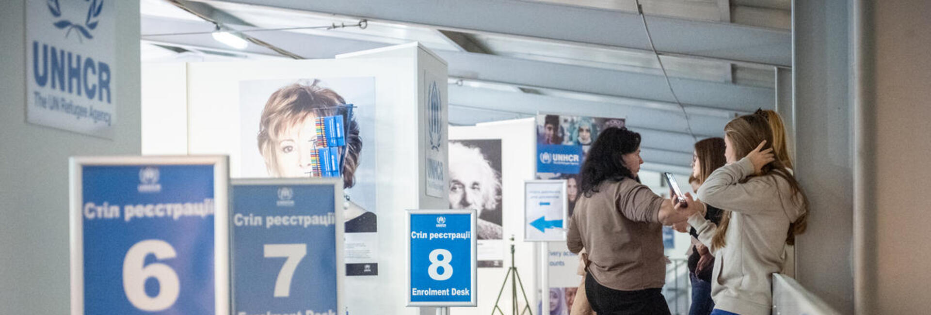 Refugee women from Ukraine are waiting in line to be registered for cash assistance