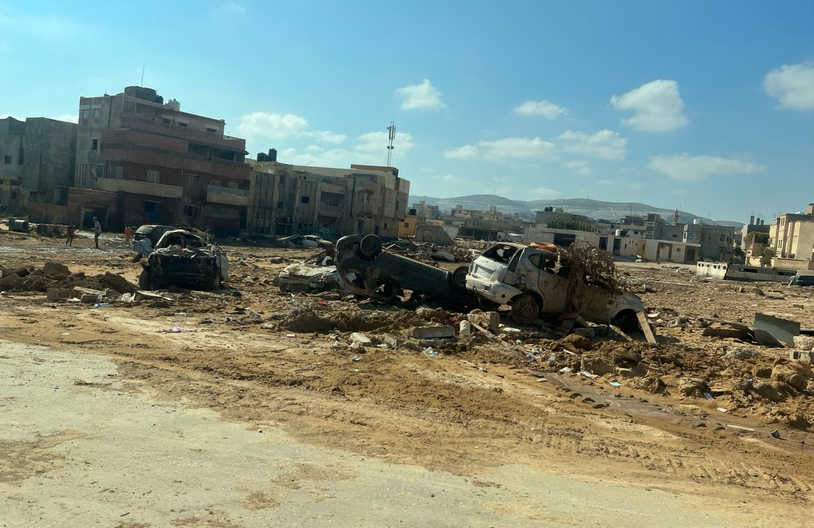 Wrecked cars lie in an area of wasteland after deadly floods in the Libyan city of Derna.
