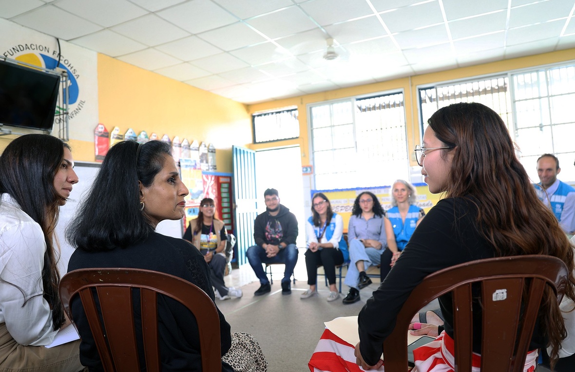 A group of people sit in a circle in a classroom in Honduras