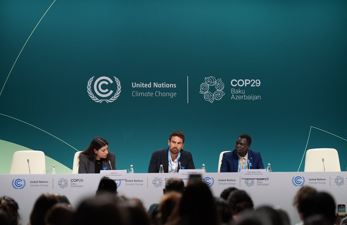 A woman and two men address a session at COP29.