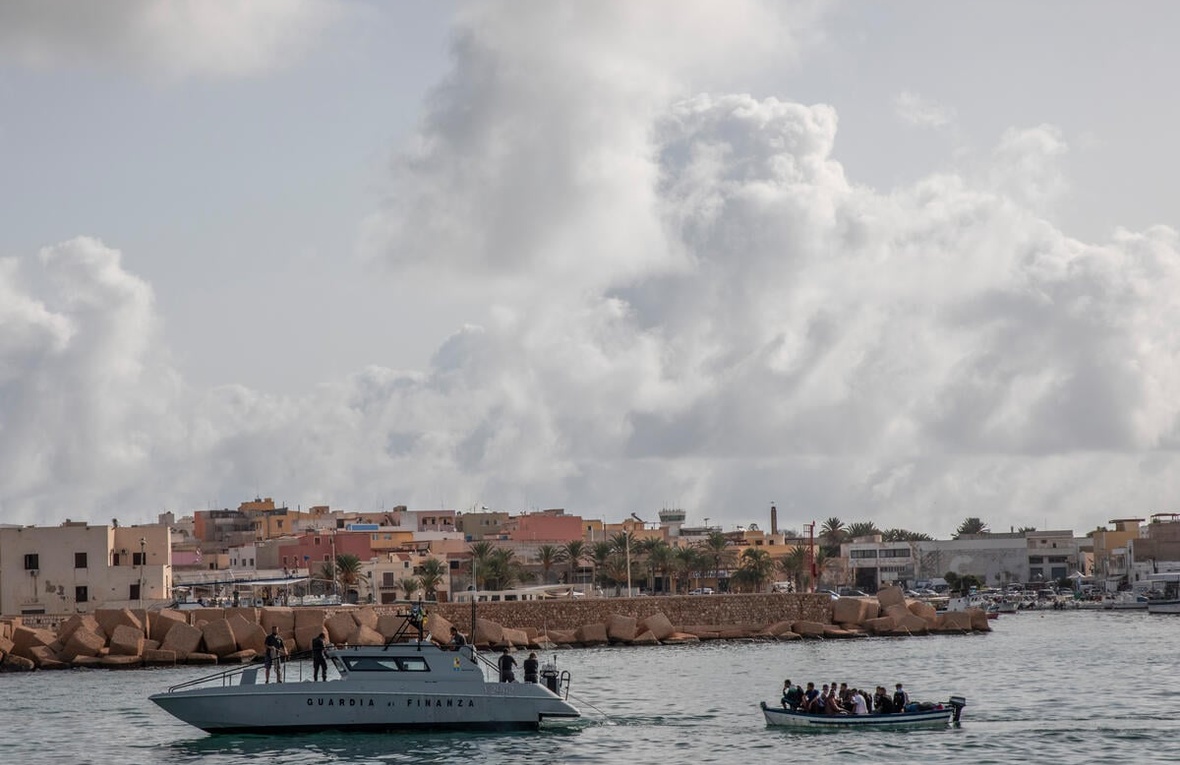 Rescued refugees and migrants disembark in Lampedusa