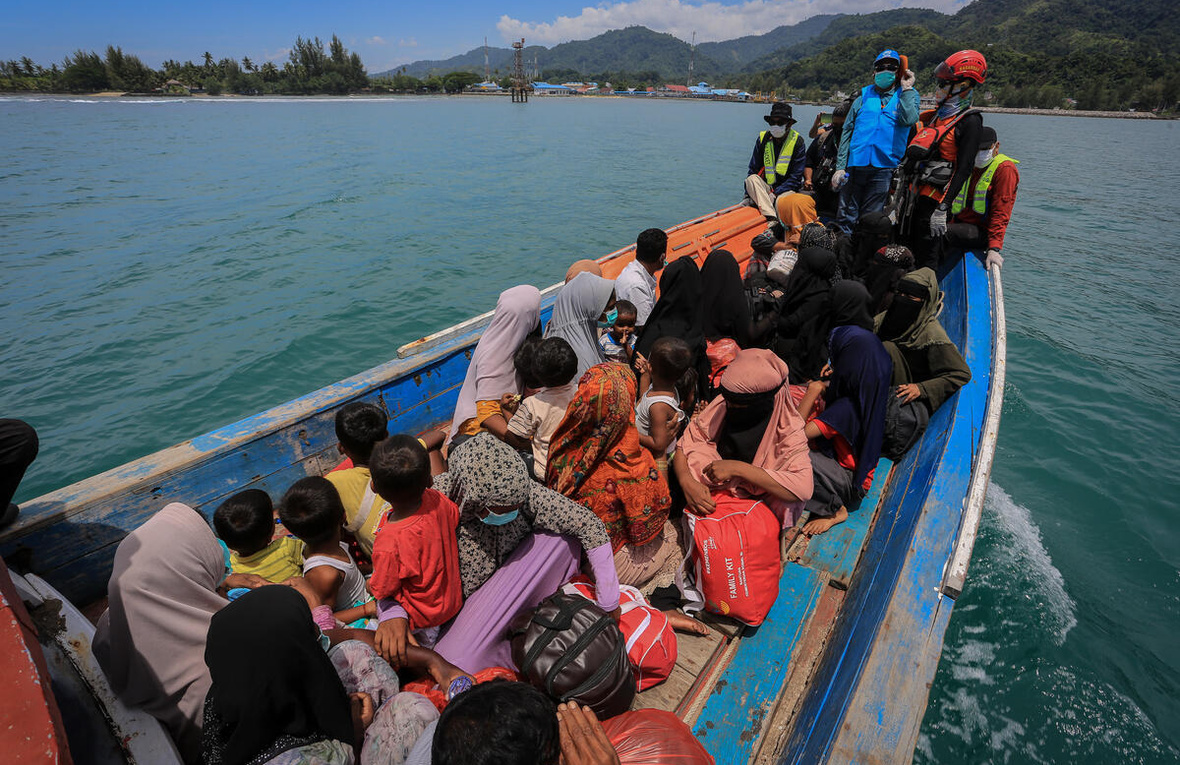 Rohingya refugees sit in a packed boat off the coast of Indonesia.