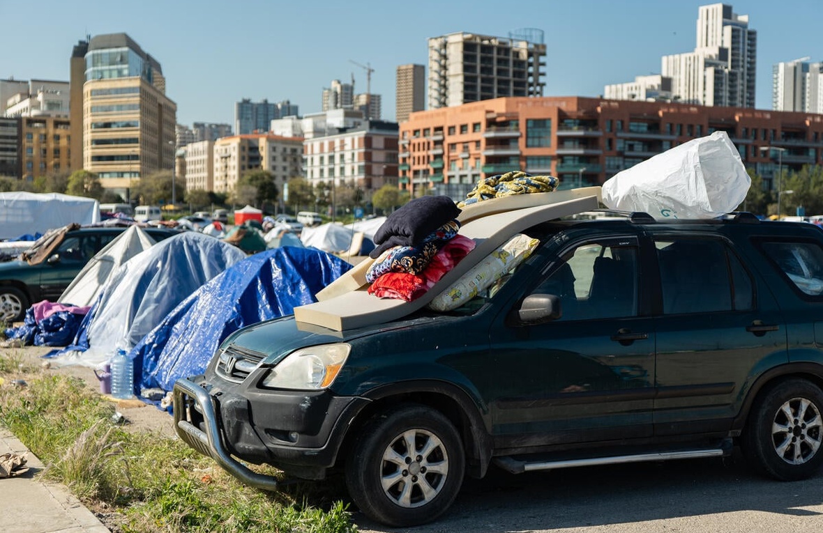 Tents and cars line Beirut's waterfront, sheltering displaced families.