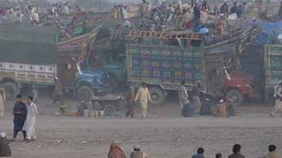 Afghan refugees returning home wait at the Takhtabaig Voluntary Repatriation Centre.