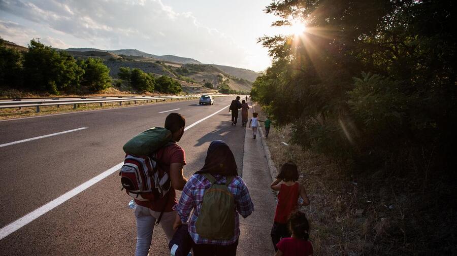Macedonia. Syrian refugees walk main highway