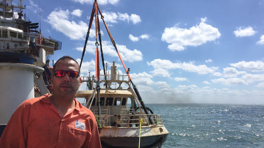 Egypt. Diver Emad Fath El Bab with Rosetta boat