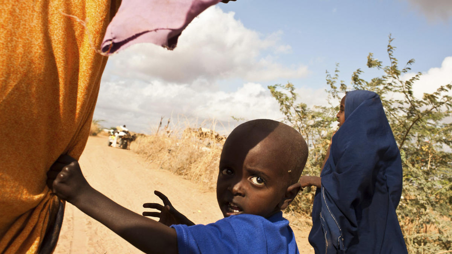 A Somali mother and her two children walk to a refugee camp at Dadaab, Kenya. The camp is the biggest in the world and has seen an influx of 40,000 new refugees from Somalia since June, 2011. 