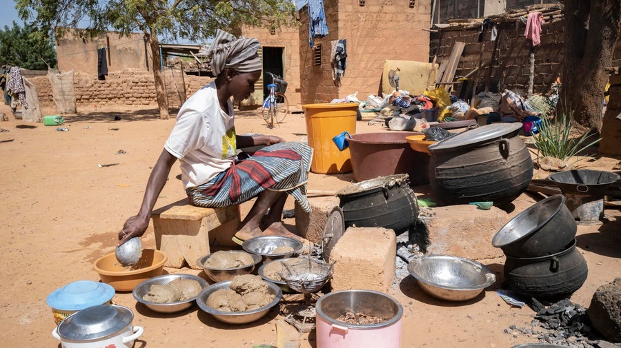 A displaced woman cooks food at a relative's house in Kaya, Burkina Faso. 