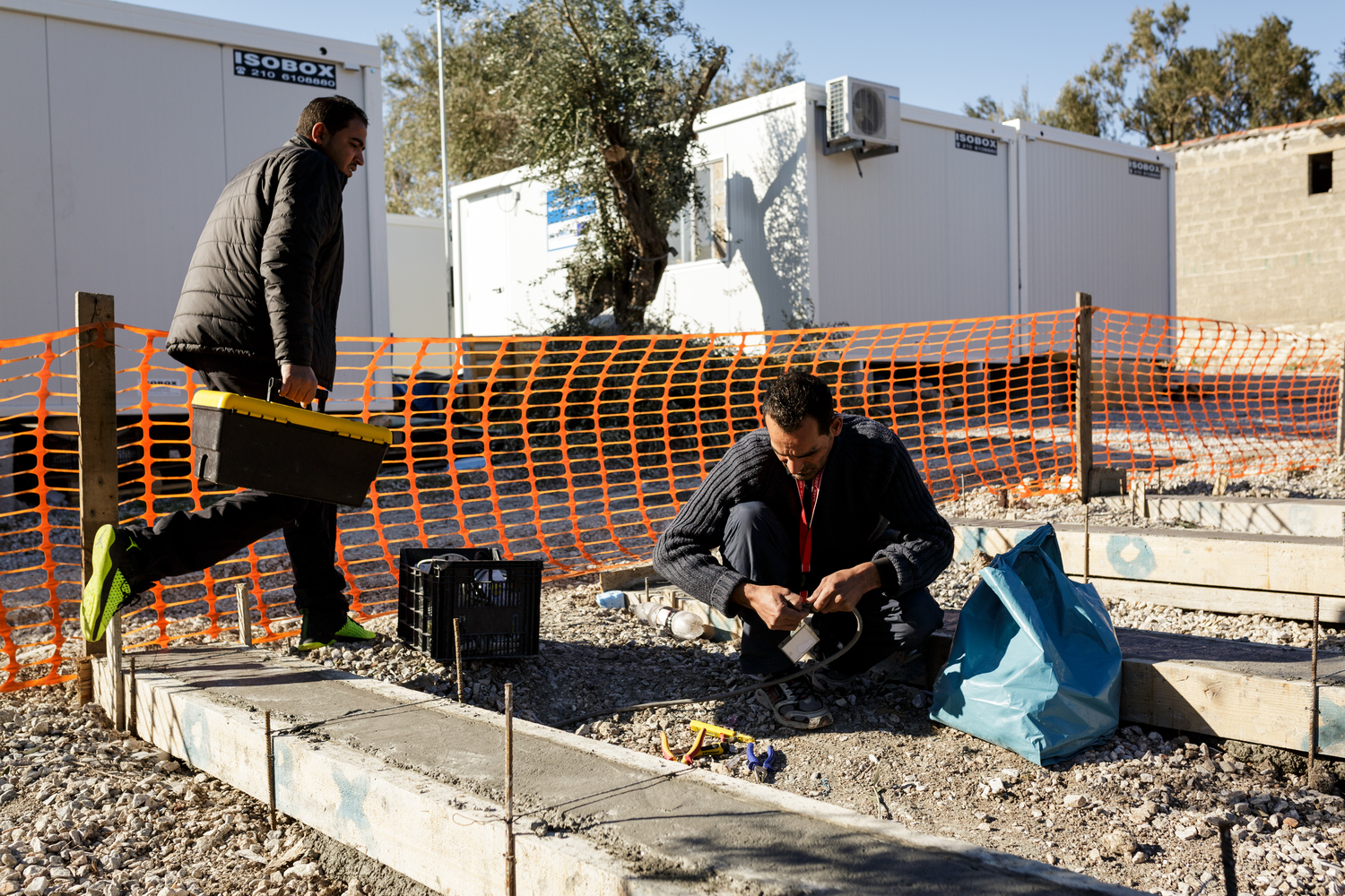 Greece. The Syrian electrician installing power at Lesbos refugee camp