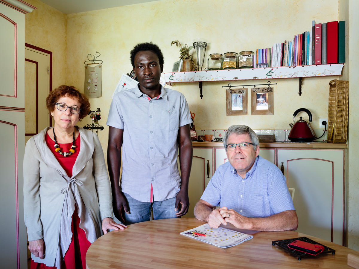 France. Annick and Hubert host Farah, a refugee from Sudan, in Rivière.  This portrait is part of the No Stranger Place series, which portrays locals and refugees living together