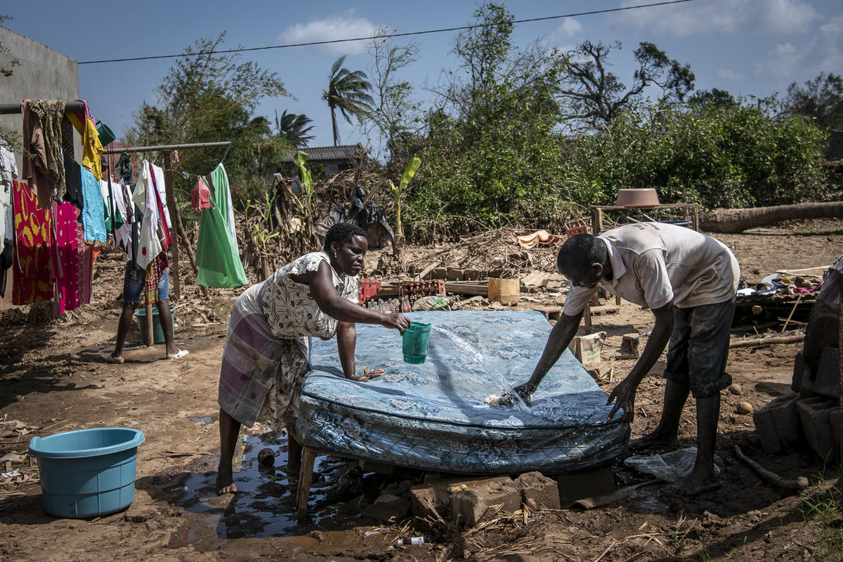 Mozambique. A husband and wife wash their mattress in the sun