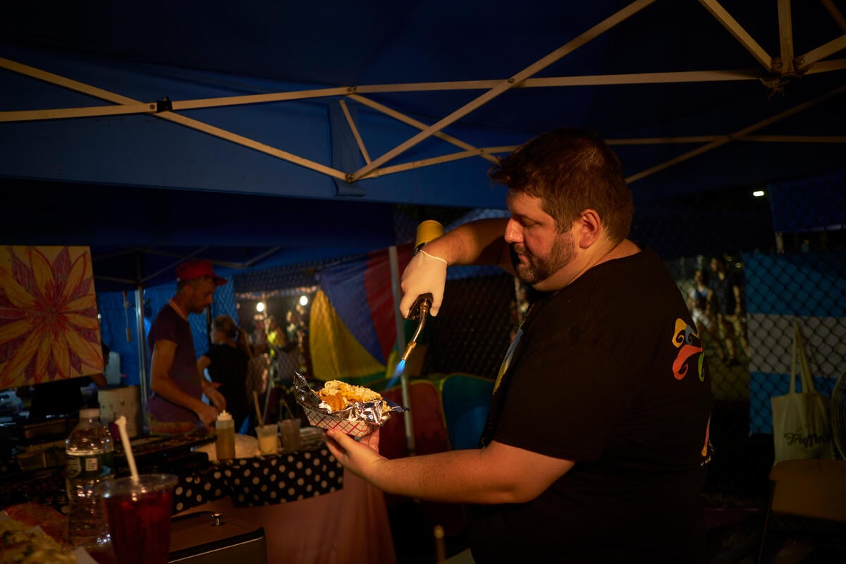 USA – Sam Ilyayev serves up Ukrainian blintzes at the Queens Night Market