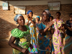 Women clap and dance together.