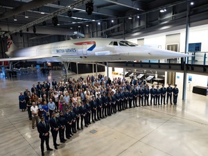 Attendees at a TUI Airline pilot certification ceremony stand in front of a Concorde airliner at Aerospace Bristol, UK.
