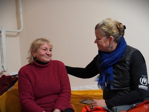 Two women sit together, talking