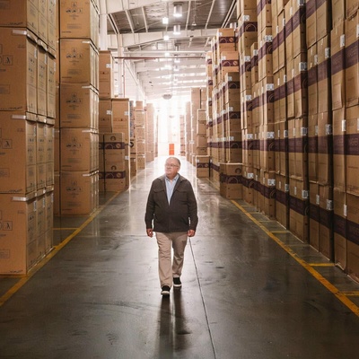 A man walks in the middle of a warehouse