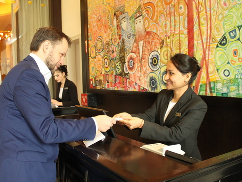 Tajikistan. Afghan refugee Nargis, confidently receiving a guest at the Front Desk, during the Apprenticeship Programme at the renown Sheraton Hotel in Dushanbe