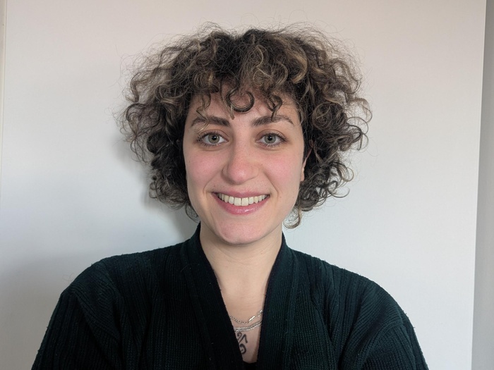 A headshot of a woman smiling.