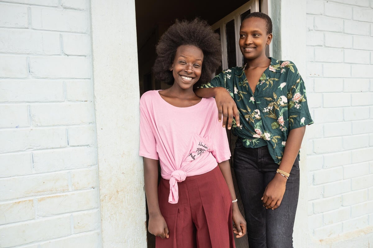 Two smiling sisters wearing clothing donated by Inditex