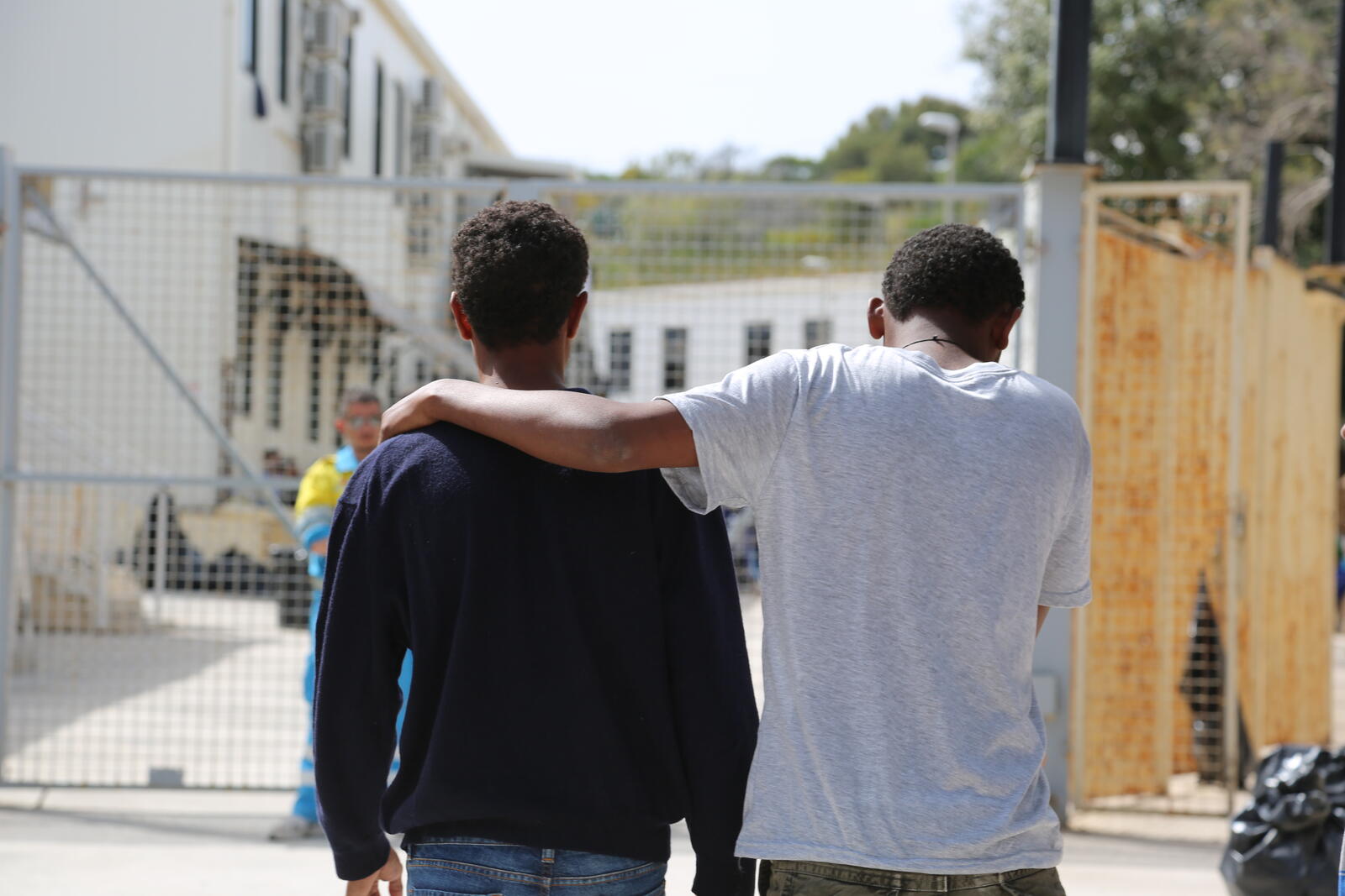 These two rescued men wait at a reception centre in Lampedusa for news of friends and relatives in need of medical treatment.