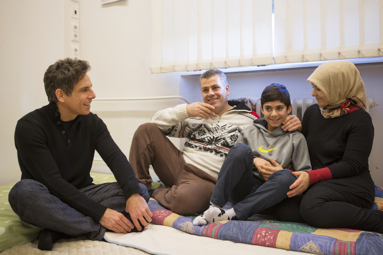 Germany. Actor Ben Stiller meets Nahed and her family at an emergency shelter in Berlin