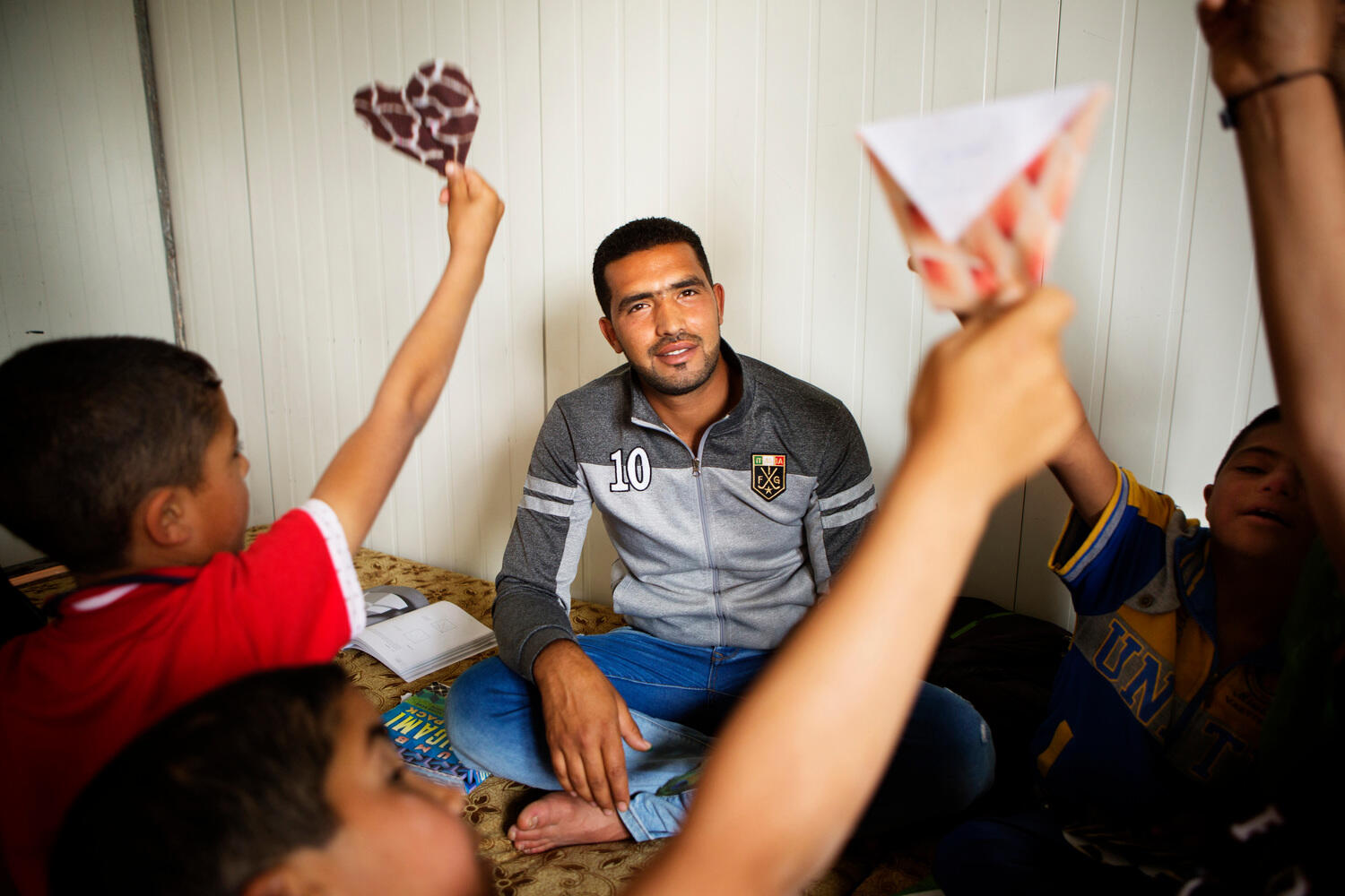 Jordan. 25-year-old Fadi Al Wali teaches origami to special needs children and other children at Za'atari refugee camp.