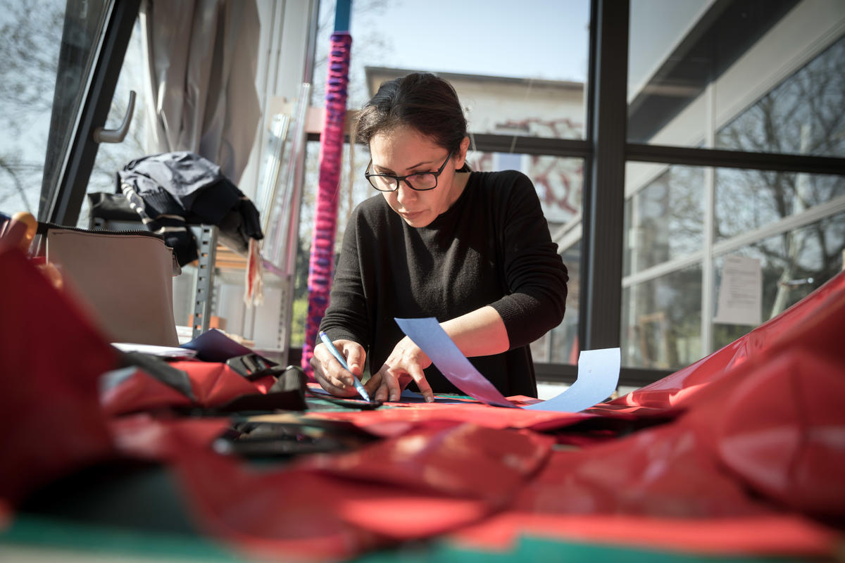 Germany. A non-profit initiative is employing newcomers to upcycle broken refugee boats into thought-provoking products.