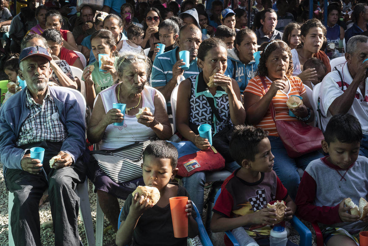 Colombia. Venezuelan migrants are given bread at a charitable feeding center