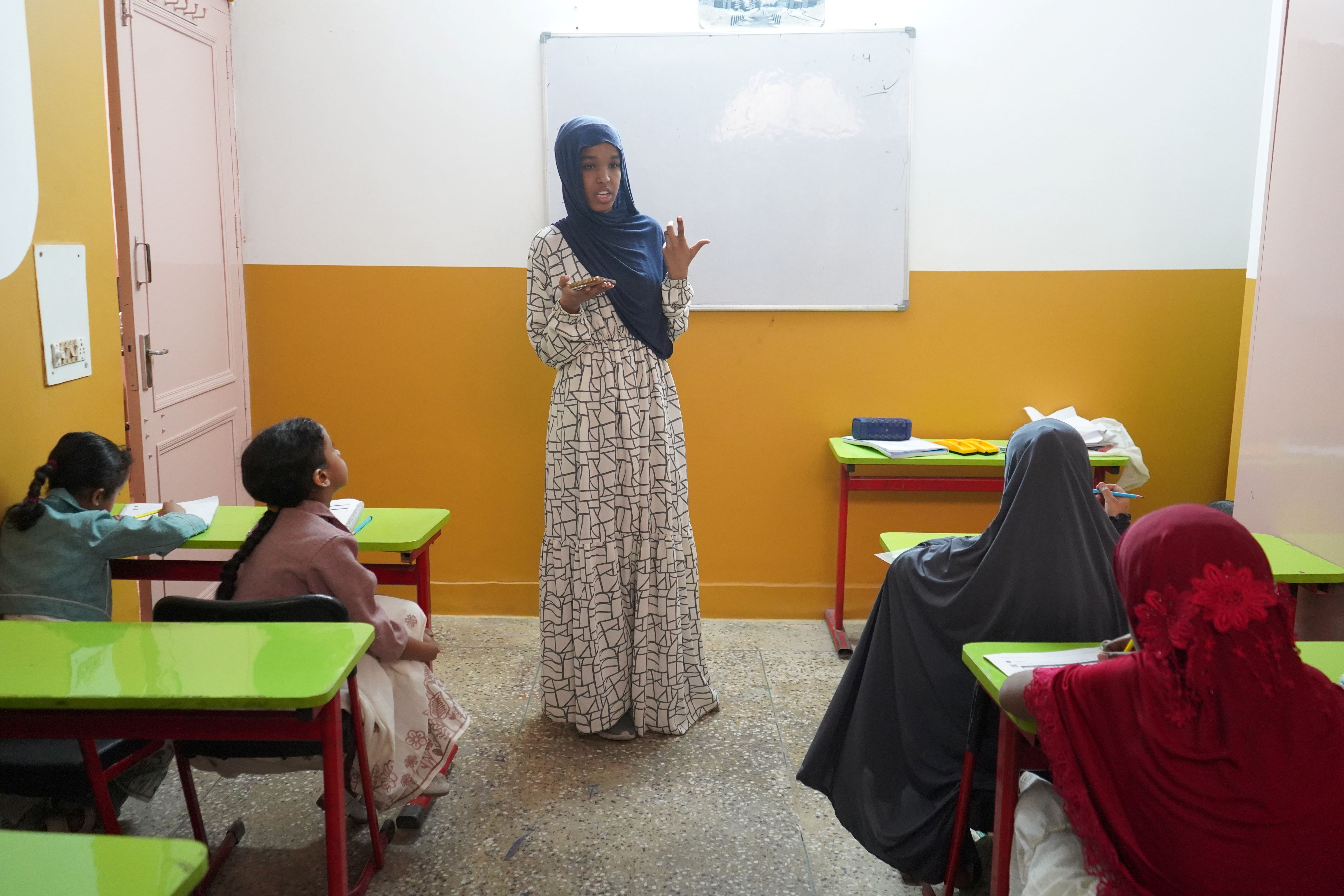 Nimco supports younger students in learning English, who is also a learner herself at the same Centre.