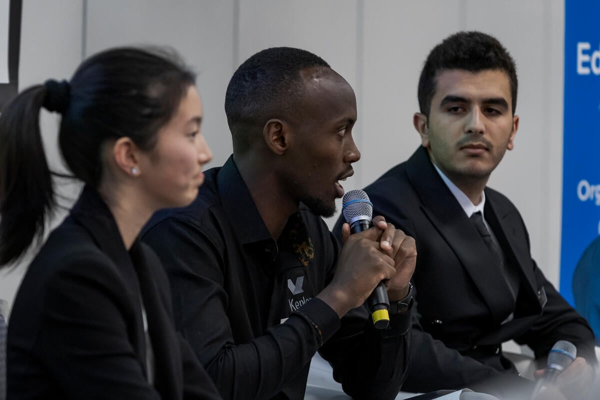 Three people speak on a panel
