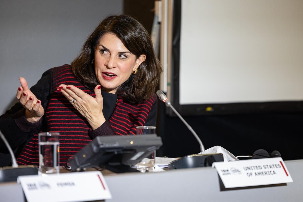 A woman speaks animatedly into the microphone