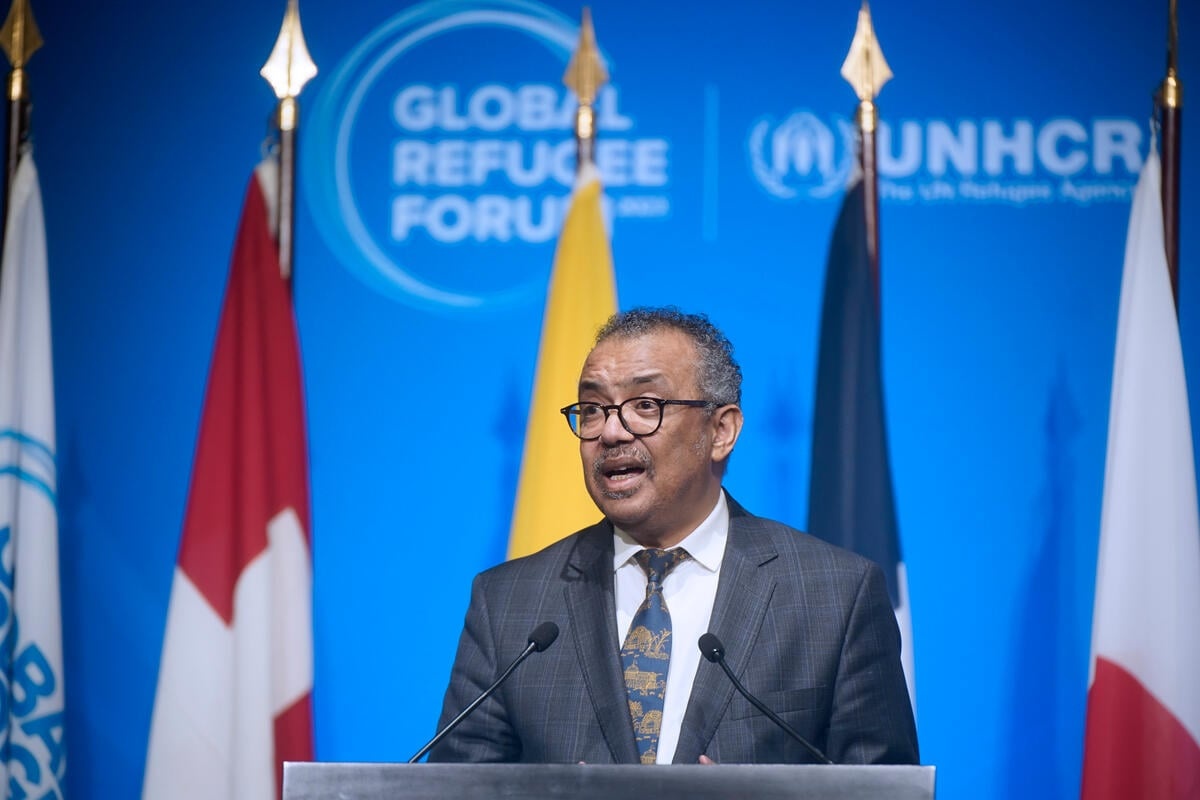 Dr. Tedros Adhanom Ghebreyesus speaking at a podium with flags and the GRF banner behind him