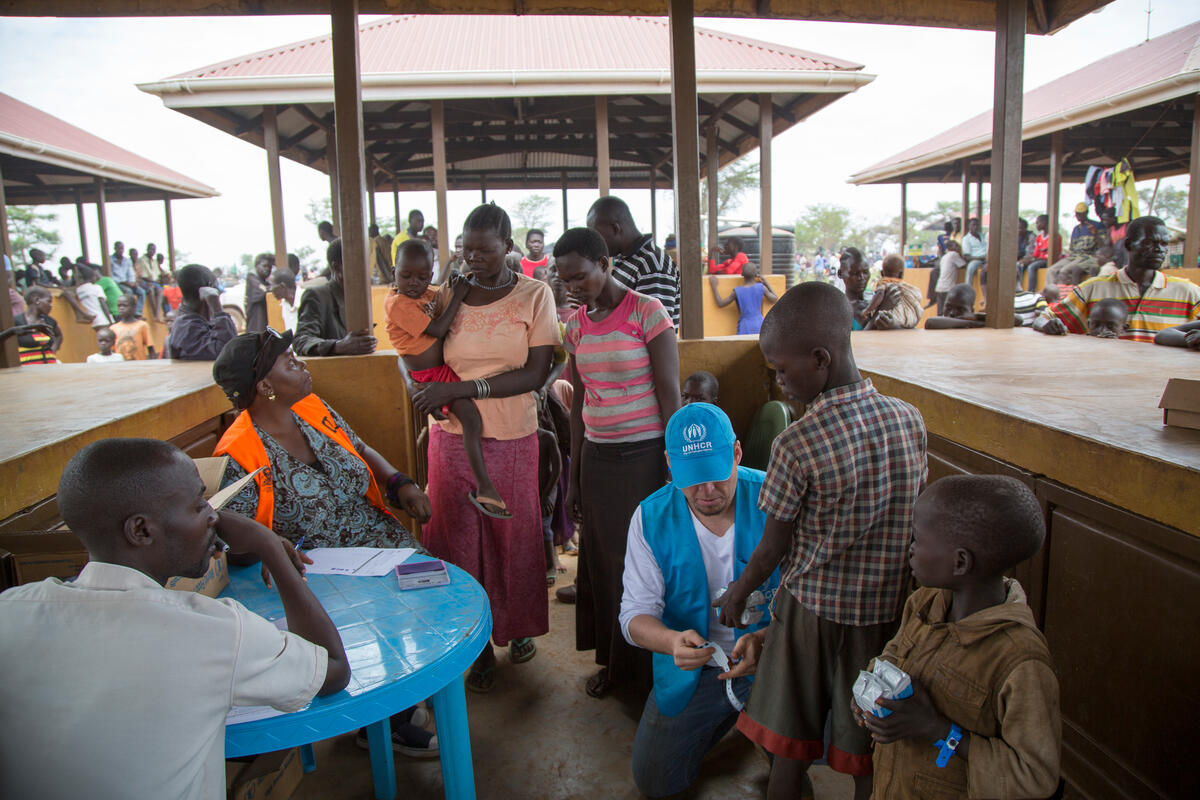 Uganda. Wristanding new arrivals