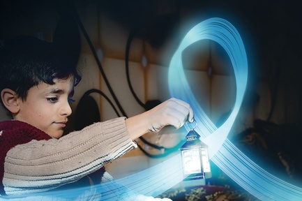 A young boy is holding a small lantern in a dark room. A blue, shiny and flying ribbon floats around the lantern.
