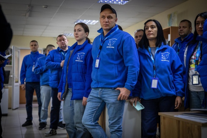 A group of people wearing the same blue vest
