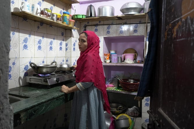 Amina Begum(name changed)  cooks a meal for her family in their small, rented home in Delhi. Rising LPG prices have forced refugee families to reduce cooking time and carefully ration every meal