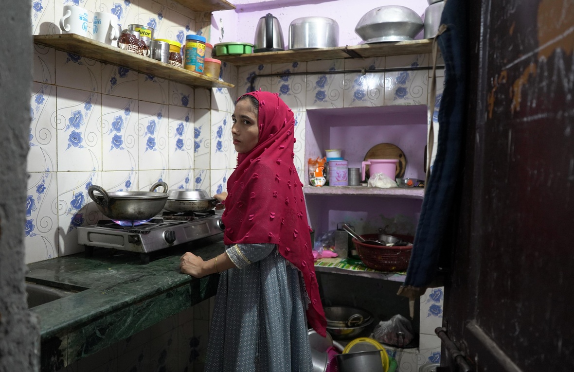 Amina Begum(name changed)  cooks a meal for her family in their small, rented home in Delhi. Rising LPG prices have forced refugee families to reduce cooking time and carefully ration every meal