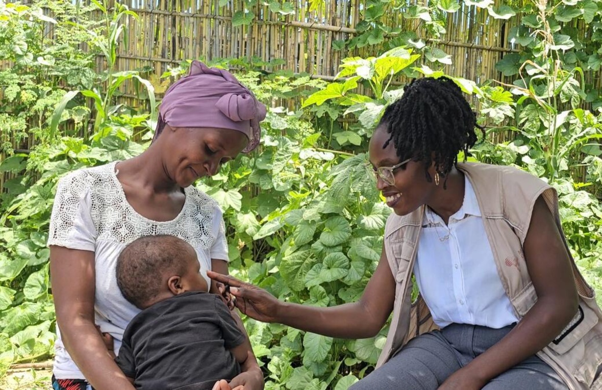 Psychologist Ancila shares a joyful moment with Viaze Abudo and her baby.
