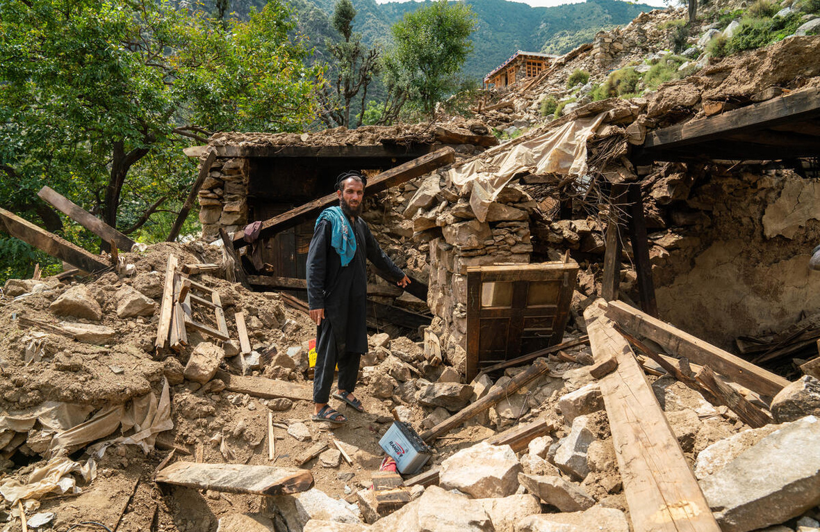 A man points at the rubble of his home following an earthquake in Kunar province, eastern Afghanistan.