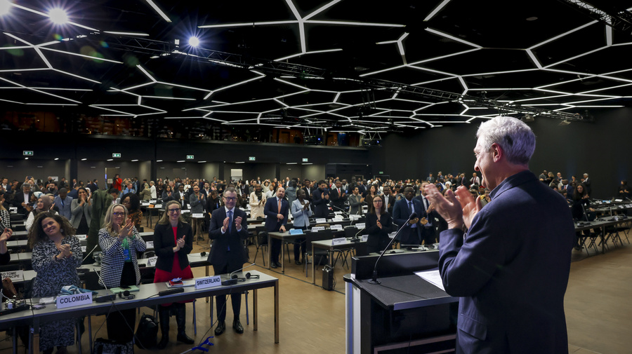 UN High Commissioner for Refugees, Filippo Grandi, stands and applauds during the closing session of the Global Refugee Forum. 