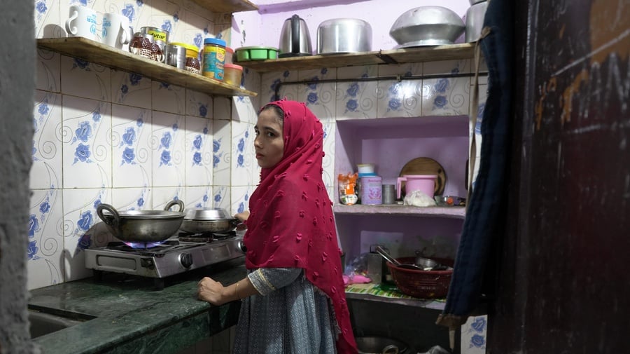 Amina Begum(name changed)  cooks a meal for her family in their small, rented home in Delhi. Rising LPG prices have forced refugee families to reduce cooking time and carefully ration every meal